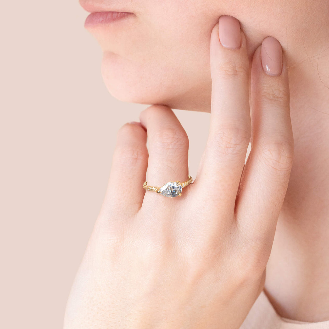 EDGY ACCENTED PEAR CUT MOISSANITE ENGAGEMENT RING