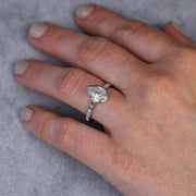Over the top view that show the ring on the finger with all finger showing.