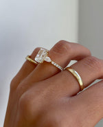 Load image into Gallery viewer, Side profile of radiant 3.0tcw lab grown diamond ring featuring a graceful cathedral shank, delicate pave diamonds, and a hidden halo beneath the center stone. A romantic and eco-conscious engagement ring or anniversary gift, designed for brides who appreciate refined brilliance.