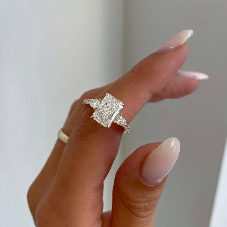 Radiant 3.0tcw lab grown diamond engagement ring featuring a cathedral setting, pave diamond accents, and a hidden halo for added brilliance. This ethically crafted ring is a perfect wedding or anniversary gift for her, combining sustainable sparkle with timeless bridal elegance.
