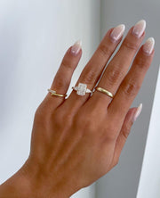 Elegant radiant cut 3.0tcw lab created diamond ring with a cathedral-style mount, hidden halo under the center stone, and pave diamond band. This engagement ring is ideal for brides who want a dazzling wedding ring with eco-friendly, conflict-free diamonds and classic charm.