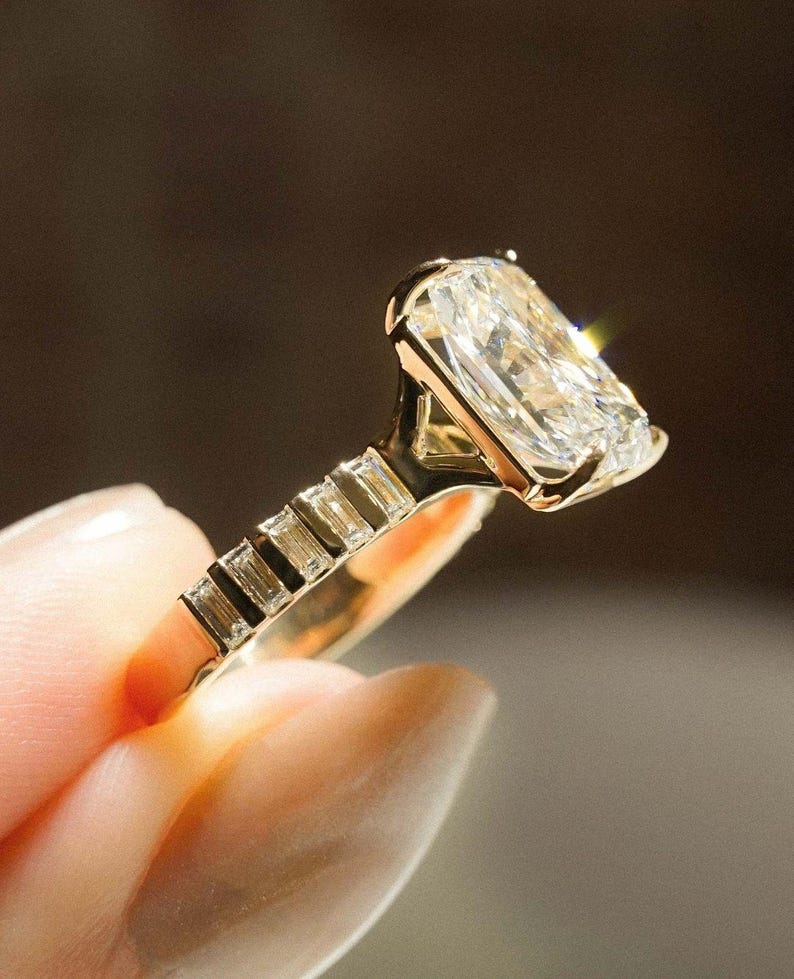 Close-up of radiant 5.15 carat total weight lab grown diamond ring with intricate pave work and split shank structure. A dazzling custom engagement ring designed for high-impact proposals. This wedding ring is perfect for her, combining eco-conscious design with stunning brilliance.