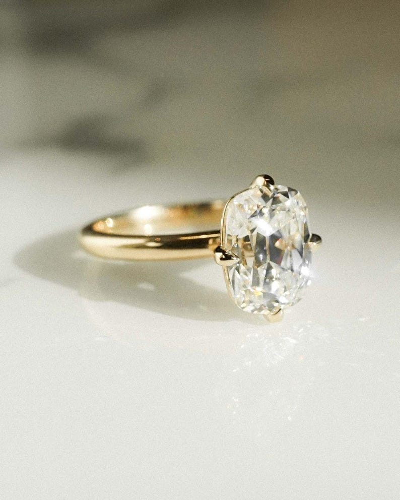 Elegant 3 carat cushion lab grown diamond ring with a raised cathedral prong setting and straight band for a balanced, timeless look. This engagement ring doubles as a unique bridal or promise ring and makes a thoughtful birthday gift for her.