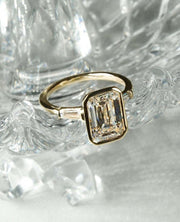 2.5ct emerald cut lab grown diamond ring with tapered side stones. A stunning engagement or anniversary ring — perfect for her.