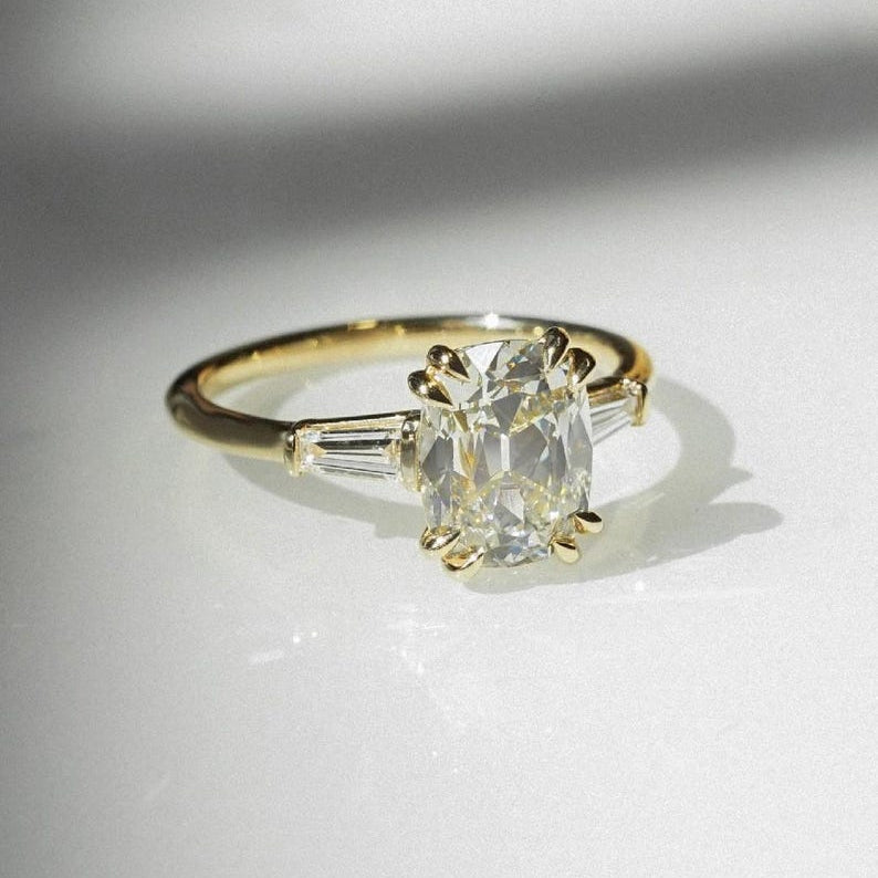 Cushion cut 1.60ct lab grown diamond engagement ring featuring a double claw three stone setting and bold dome shank design. A forever classic ring perfect for anniversaries or birthdays, this ethically crafted diamond ring for her offers timeless beauty and modern elegance.
