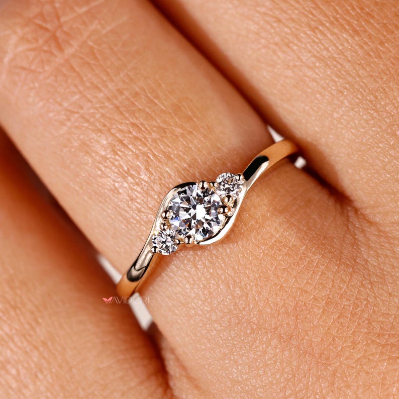 Round cut diamond ring with a 3 stone setting for a sophisticated touch.