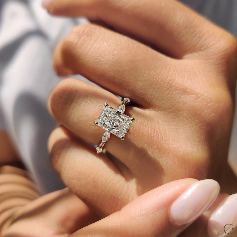 5 diamond ring designed with radiant center sparkle.