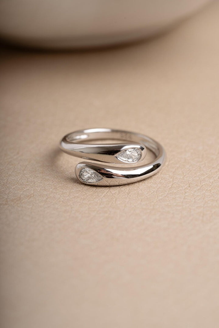 Sterling silver statement ring on beige surface