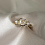 Load image into Gallery viewer, Asscher Cut Trilogy Diamond Engagement Ring featuring a 1.5ct IGI Certified Asscher Cut Lab Grown Diamond with round lab grown diamond side stones in solid gold. Three-stone engagement ring with 1.82ct total carat weight.
