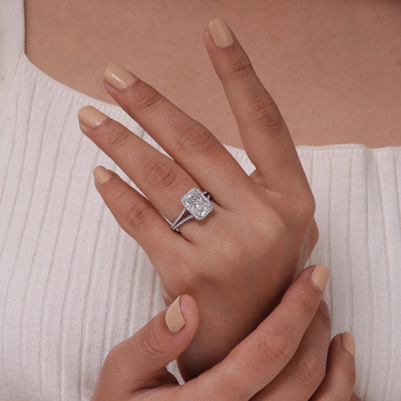 Lab grown radiant cut diamond halo engagement ring with split shank band in 18k gold.