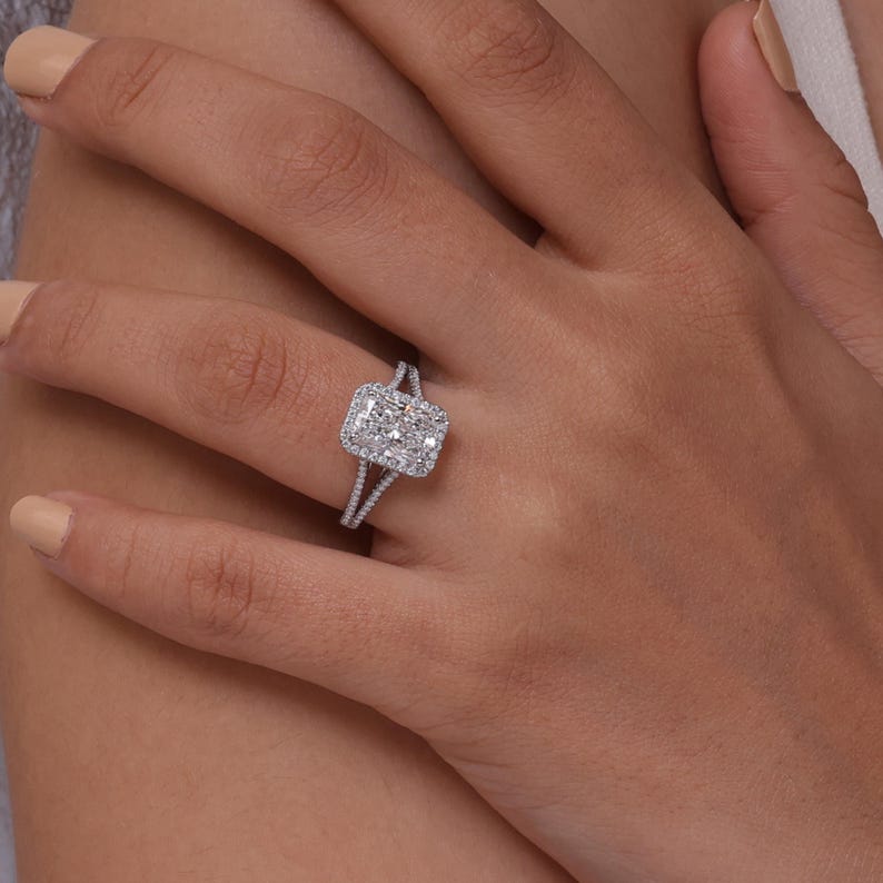 Lab grown radiant cut diamond halo engagement ring with split shank band in 10k gold.