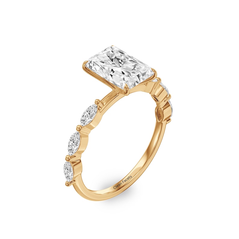 14k gold diamond engagement ring with marquise cut side stone.