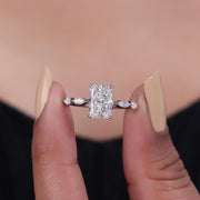 Radiant cut lab grown diamond engagement ring with marquise side stone set in prong.