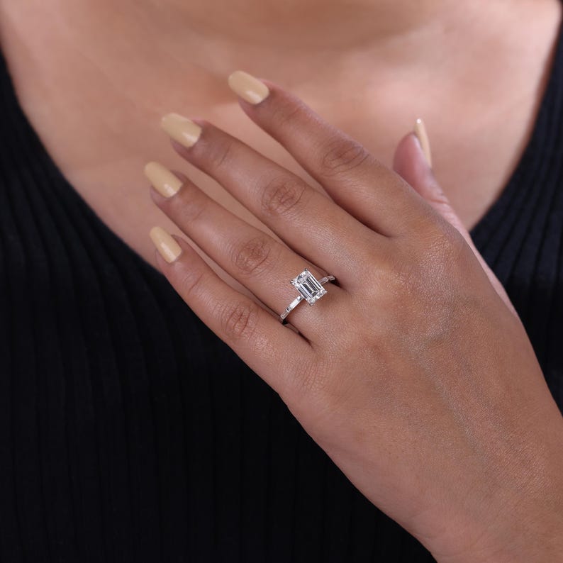 Emerald cut lab grown diamond solitaire engagement ring in sterling silver.