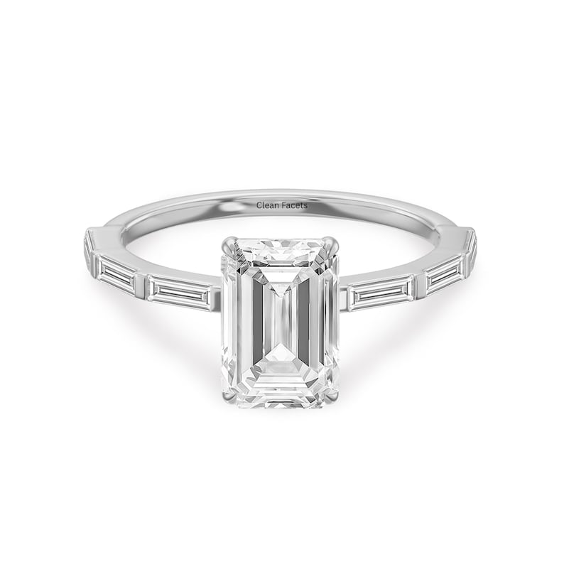 14k white gold ring featuring emerald cut lab grown diamond with baguette side stone.