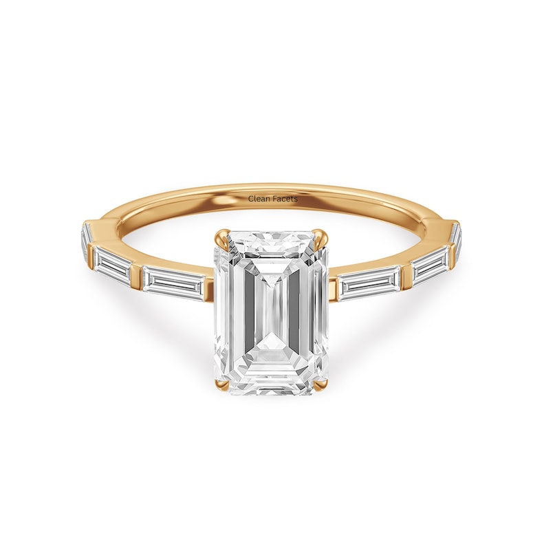 14k yellow gold ring featuring emerald cut lab grown diamond with baguette side stone.