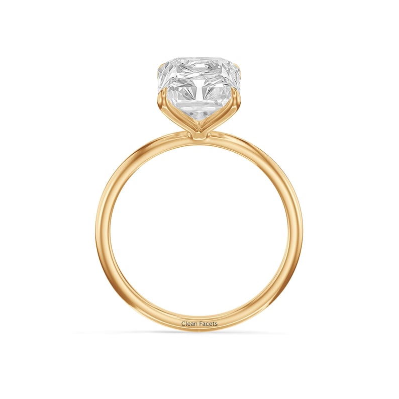 18k yellow gold ring featuring radiant cut lab grown diamond set in 4 claw prongs.