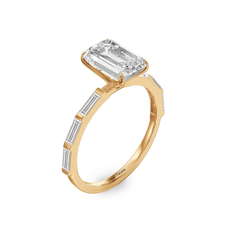 18k yellow gold lab grown emerald cut and baguette diamond side stone engagement ring.