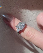 Load and play video in Gallery viewer, Asscher Cut IGI Certified Lab Diamond Ring, Trillion Side Stones Band