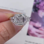 Load and play video in Gallery viewer, Asscher 5.40tcw Lab Diamond Ring | Trapezoid Side Stones | Three Stone | IGI Certified